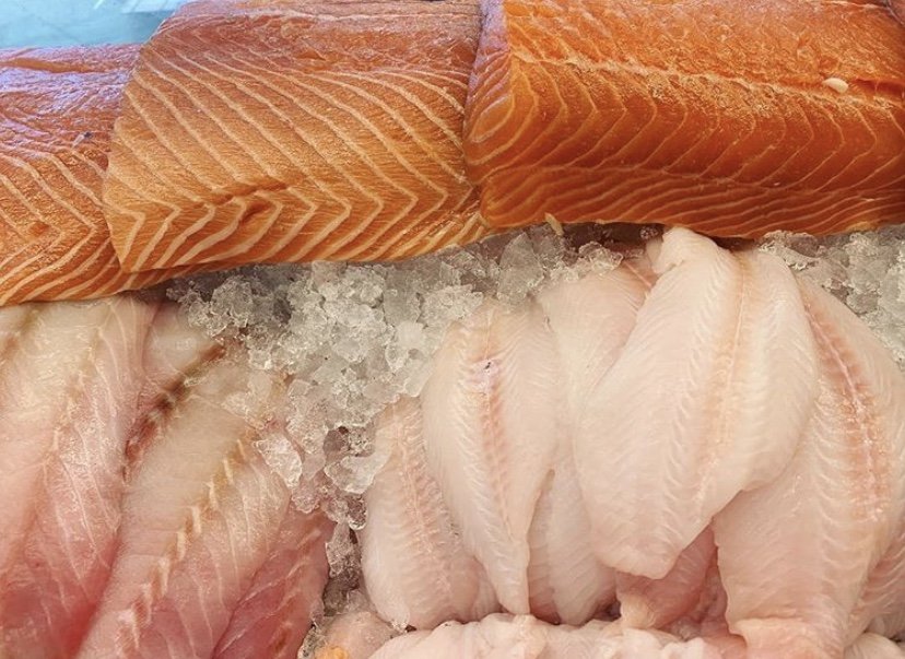Fresh fish displayed on a market counter.